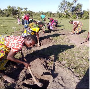 The Gwafe CFBO replanting trees after an environmental training. 